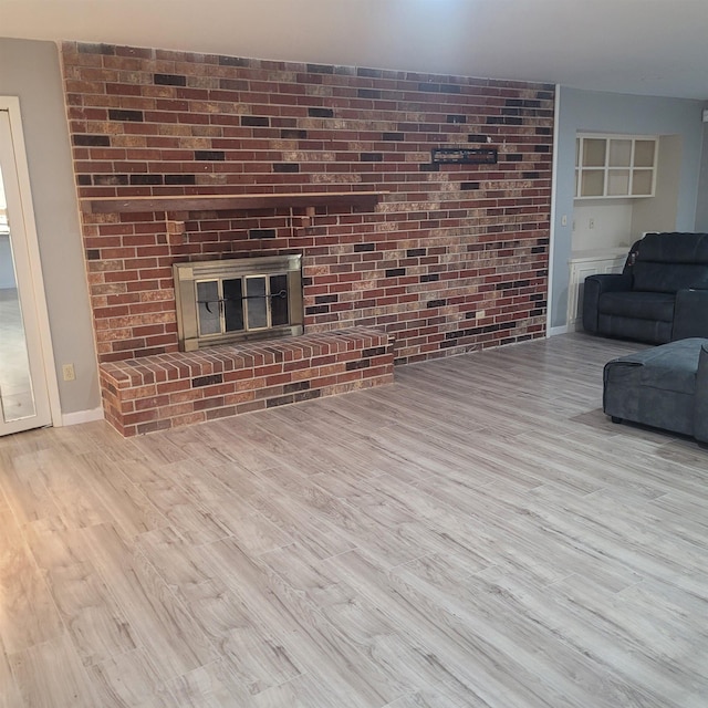 living room featuring a fireplace and light hardwood / wood-style floors