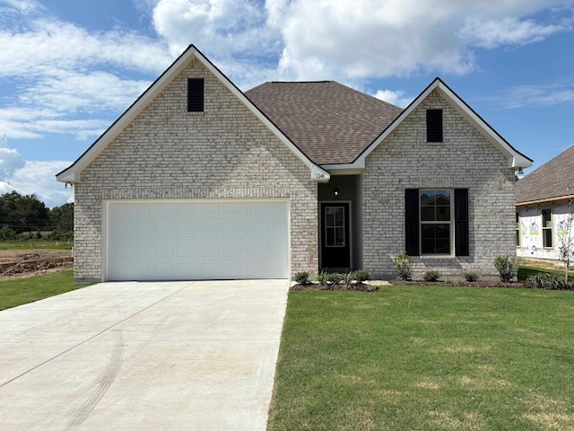 1240 Little Cypress Loop, Orange, TX 77632 - traditional-style home featuring driveway, a front yard, an attached garage, a shingled roof, and brick siding