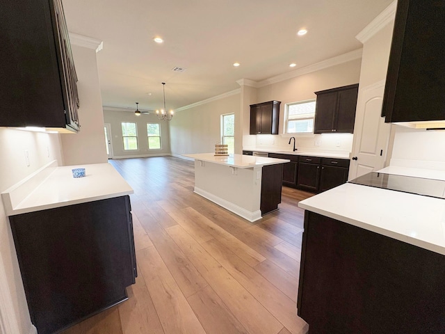 1240 Little Cypress Loop, Orange, TX 77632 - kitchen featuring ornamental molding, a sink, a center island, open floor plan, and light wood-style floors