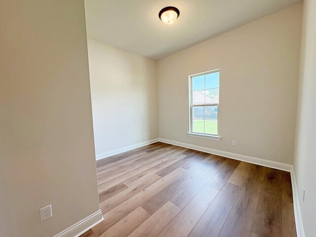 1240 Little Cypress Loop, Orange, TX 77632 - spare room featuring baseboards and hardwood / wood-style flooring