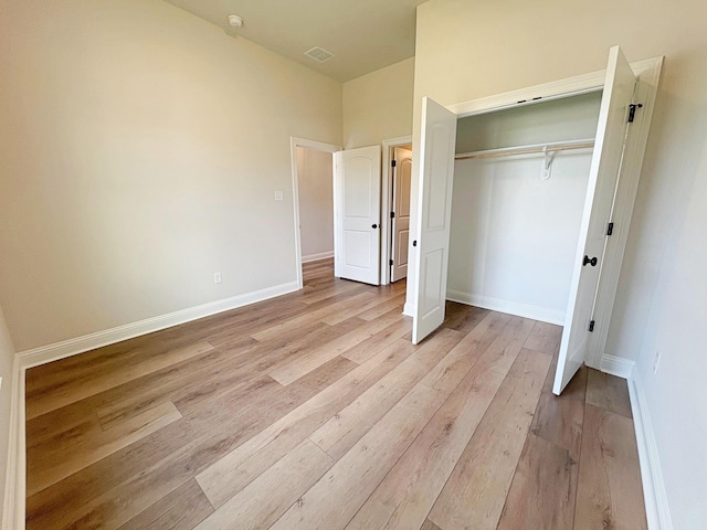 1240 Little Cypress Loop, Orange, TX 77632 - unfurnished bedroom with light wood-type flooring, a closet, and baseboards