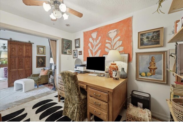 office space featuring ceiling fan and a textured ceiling