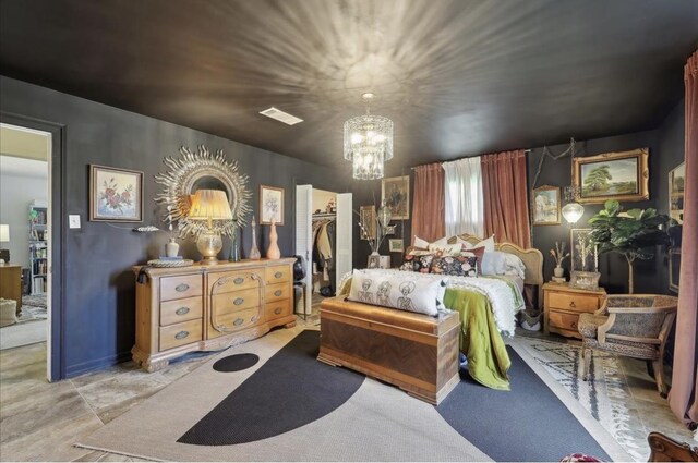 bedroom with visible vents, a notable chandelier, a spacious closet, and a closet