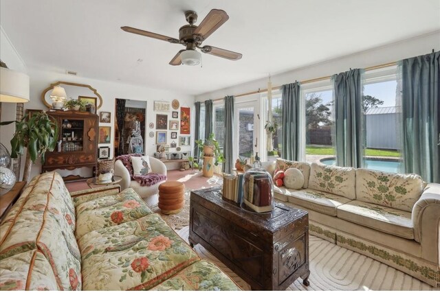 living room featuring a ceiling fan and visible vents