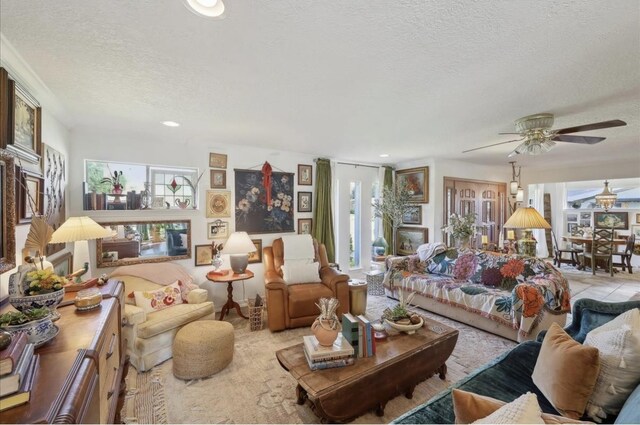 living room featuring ceiling fan, recessed lighting, and a textured ceiling