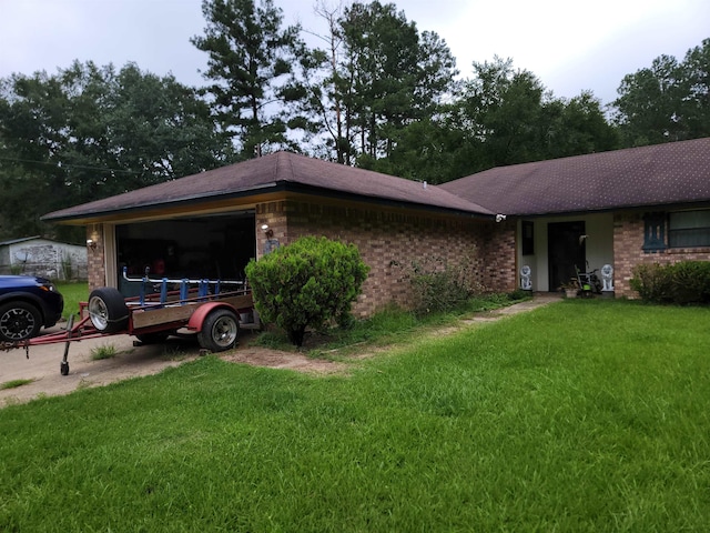 ranch-style home featuring a front yard and a garage