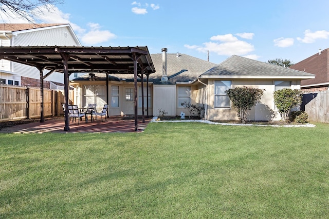 back of house with a yard and a patio area