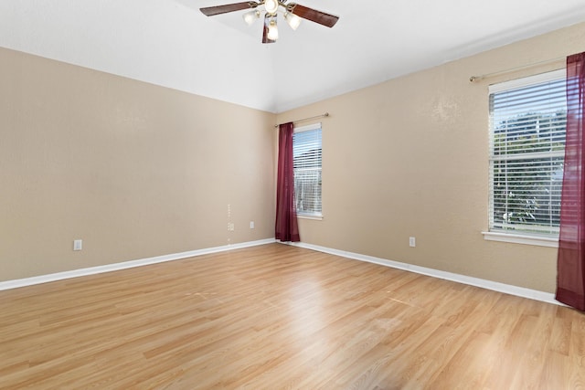 unfurnished room featuring lofted ceiling, ceiling fan, and light hardwood / wood-style flooring