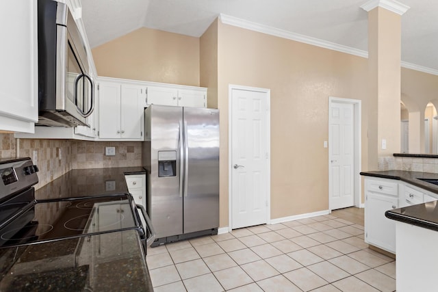 kitchen featuring white cabinetry, crown molding, vaulted ceiling, light tile patterned floors, and appliances with stainless steel finishes