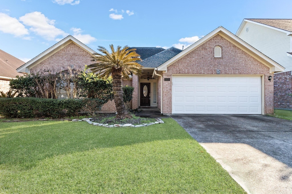 7835 Indian Blanket Dr, Beaumont, TX 77713 - view of front of house featuring a garage and a front lawn