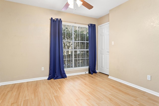 spare room with wood-type flooring and ceiling fan