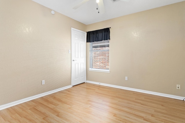 spare room featuring ceiling fan and light hardwood / wood-style flooring