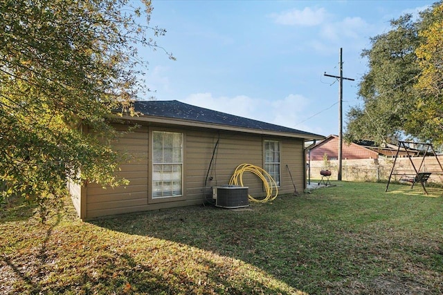 exterior space featuring a yard and central AC