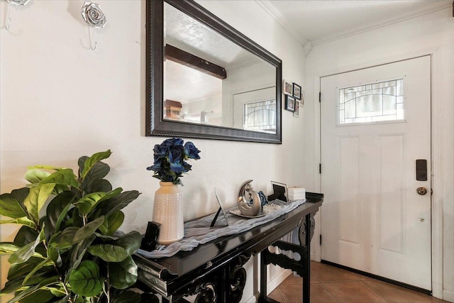 tiled entrance foyer featuring ornamental molding