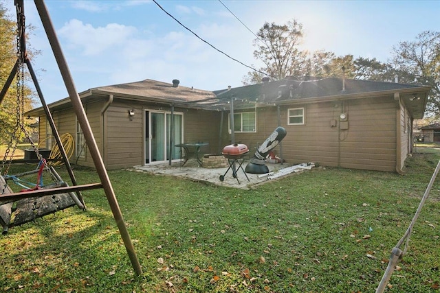 back of house with a yard and a patio