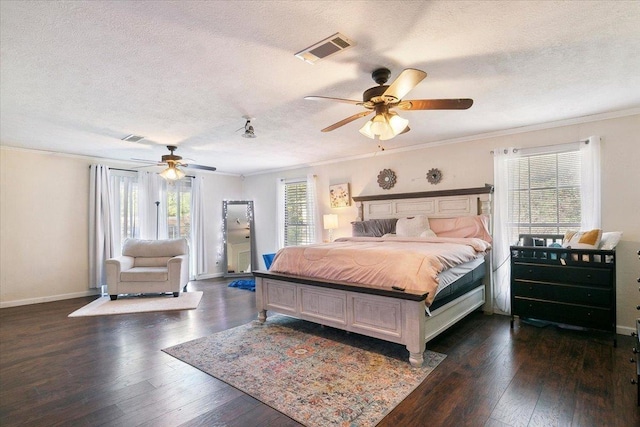 bedroom featuring ceiling fan, ornamental molding, a textured ceiling, and multiple windows