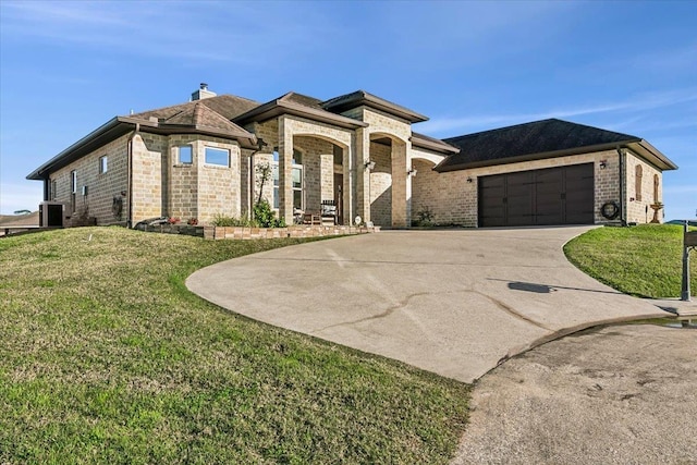 view of front facade with a front yard and a garage