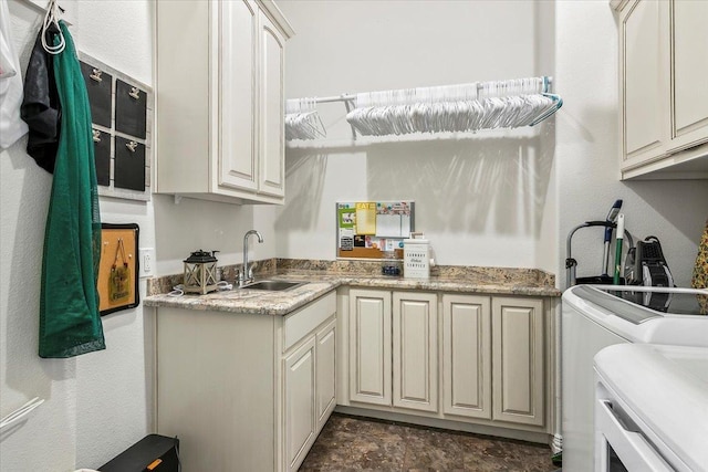 kitchen with washing machine and clothes dryer and sink