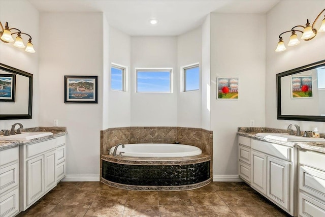 bathroom featuring vanity and tiled tub