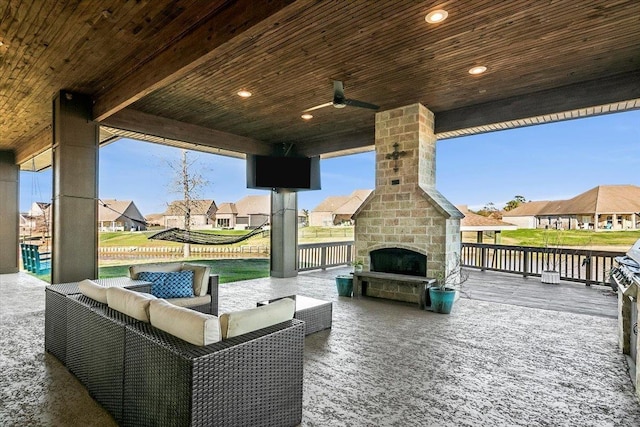 view of patio / terrace with an outdoor stone fireplace and ceiling fan