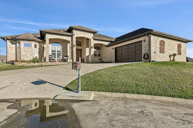 view of front of house with a garage and a front lawn