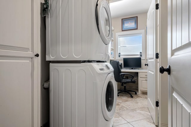 washroom with light tile patterned floors, laundry area, and stacked washer and clothes dryer