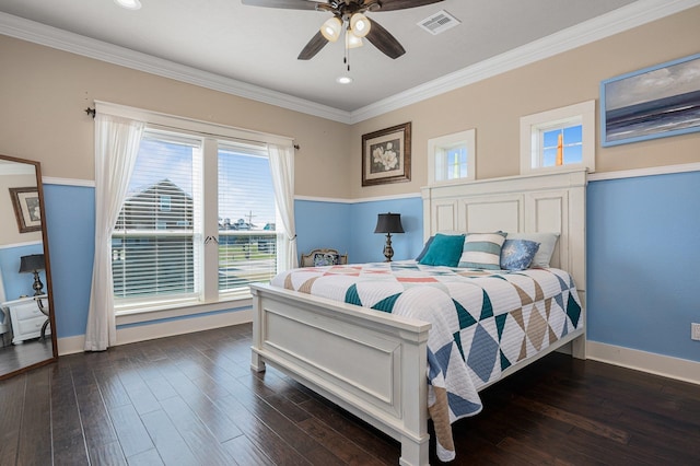 bedroom featuring dark wood-style floors, visible vents, and ornamental molding