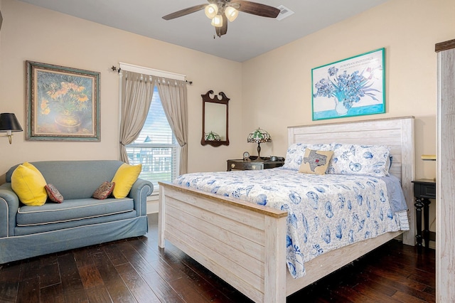 bedroom featuring a ceiling fan, visible vents, and dark wood finished floors