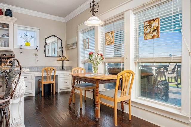 dining room with dark wood-type flooring, crown molding, and built in desk