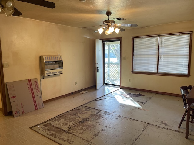 entrance foyer with ceiling fan, a textured ceiling, and heating unit