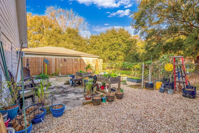 390 N Major Dr, Beaumont, TX 77706 - view of patio featuring a garden