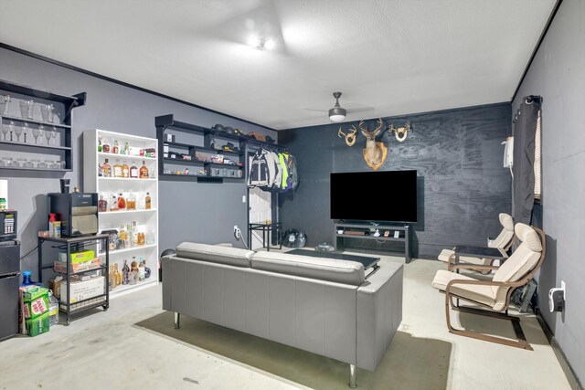 390 N Major Dr, Beaumont, TX 77706 - living area featuring ceiling fan, concrete flooring, and an accent wall