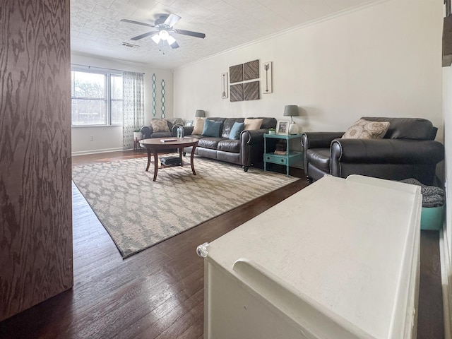 living room featuring crown molding, ceiling fan, and dark wood-type flooring