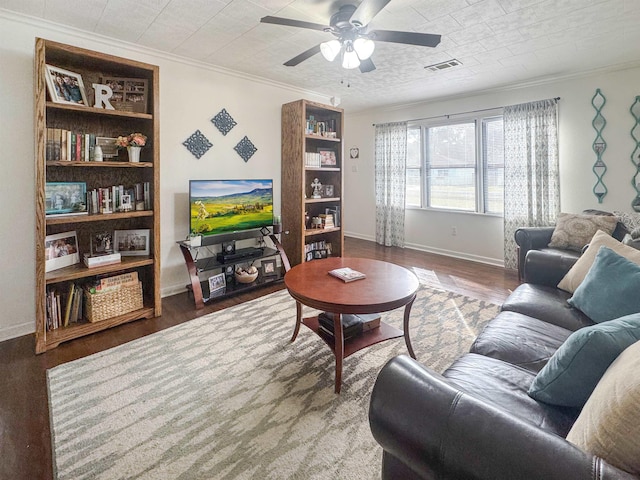 living room featuring wood-type flooring, ornamental molding, ceiling fan, and built in shelves