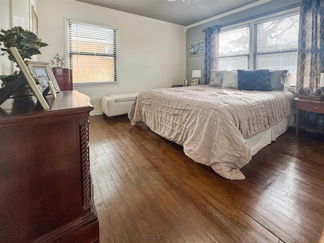 bedroom featuring crown molding and dark hardwood / wood-style floors