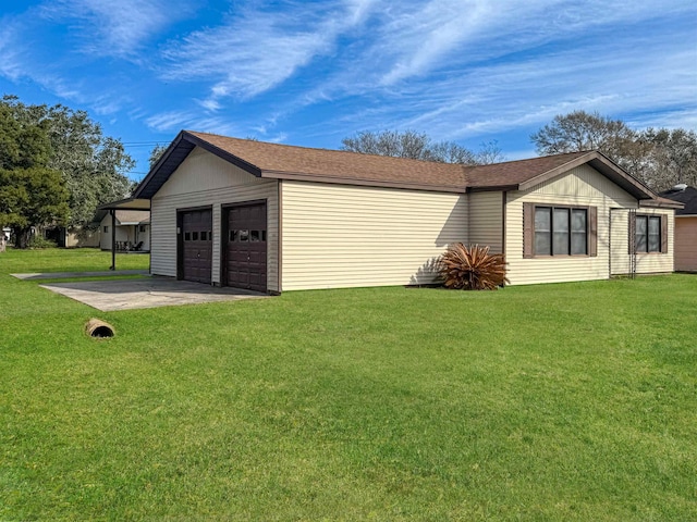 view of side of home with a garage and a yard