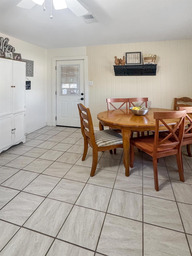 tiled dining area featuring ceiling fan