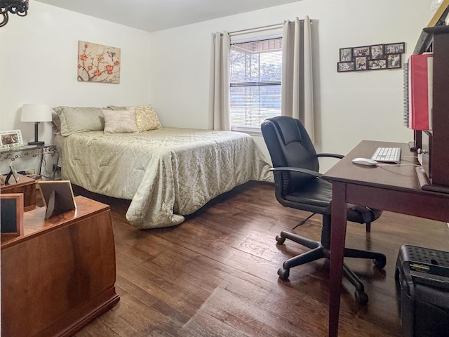 bedroom with dark hardwood / wood-style floors