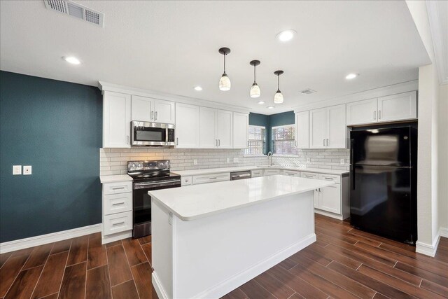 kitchen with backsplash, appliances with stainless steel finishes, white cabinets, light countertops, and wood tiled floor