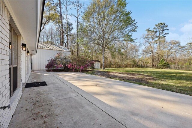 view of patio with an outbuilding