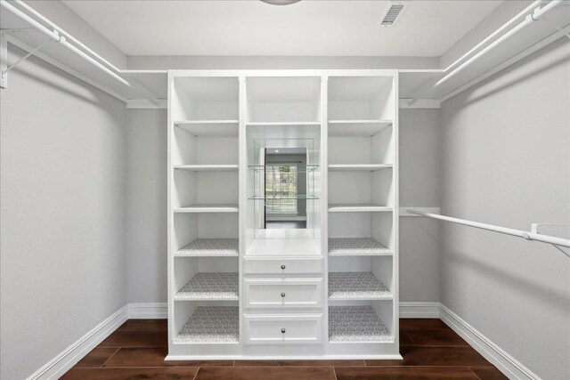 walk in closet featuring wood finish floors and visible vents