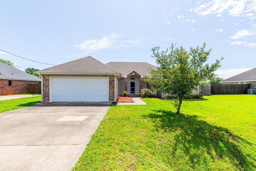 5515 Summerwood Ln, Lumberton, TX 77657 - view of front of home with driveway, brick siding, an attached garage, and cooling unit