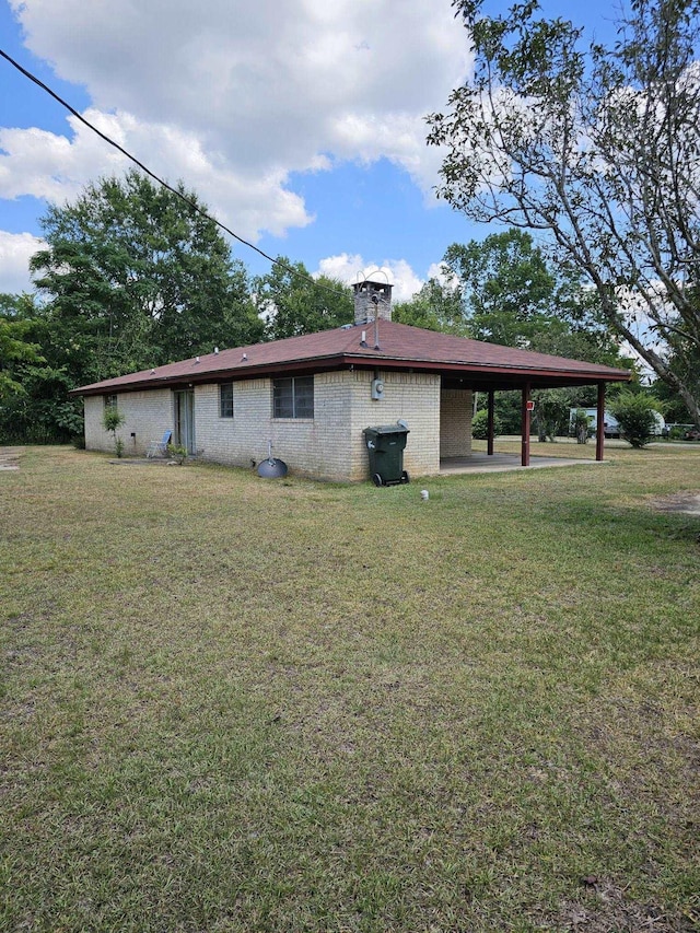 view of home's exterior with a yard and a carport