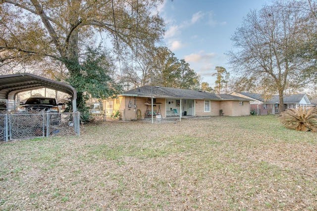 view of yard with a carport and covered porch