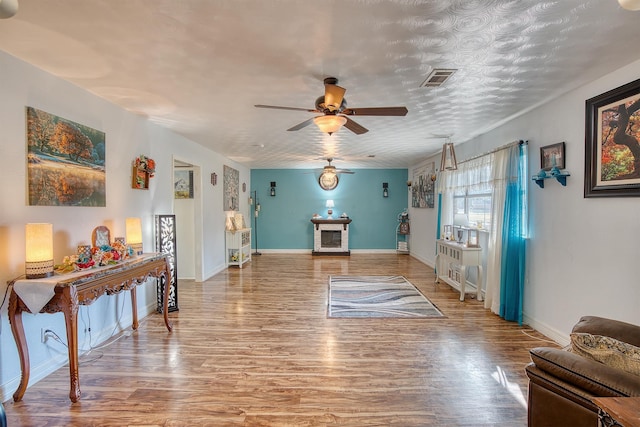 interior space with hardwood / wood-style floors and ceiling fan