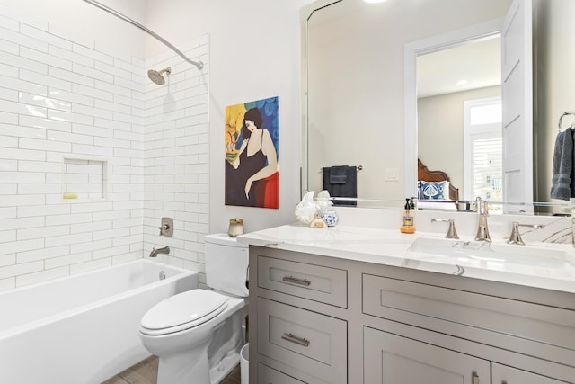 full bathroom with tiled shower / bath combo, toilet, and vanity