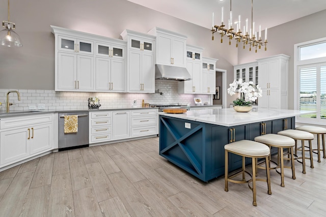 kitchen with a center island, white cabinets, and stainless steel dishwasher