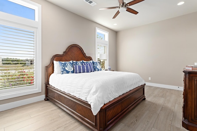 bedroom with ceiling fan and light hardwood / wood-style floors