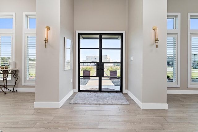 foyer with french doors and light wood-type flooring