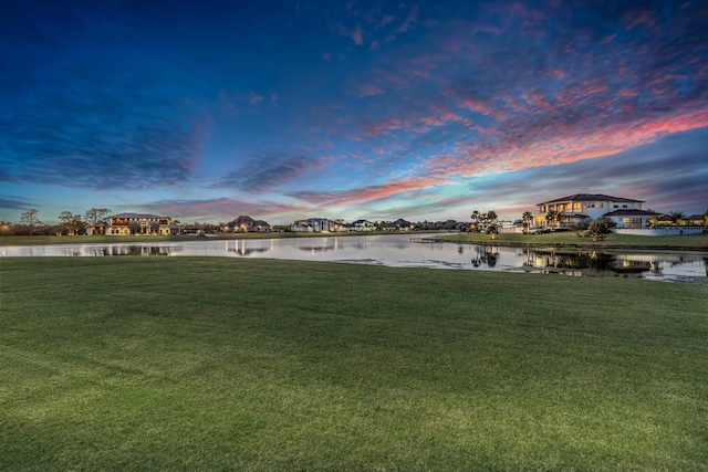 yard at dusk with a water view